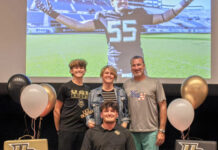 CORAL SHORES’ SMITH, KEY WEST’S MERCER TAKE THEIR TALENTS TO THE NEXT LEVEL a group of people standing in front of a table