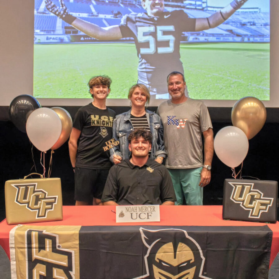 a group of people standing in front of a table