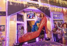 MILES TO GO: WHERE WILL YOU BE WHEN THE CLOCK STRIKES 2026? a group of people standing around a house