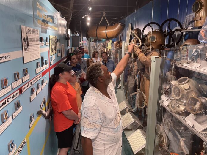 a group of people looking at items on display