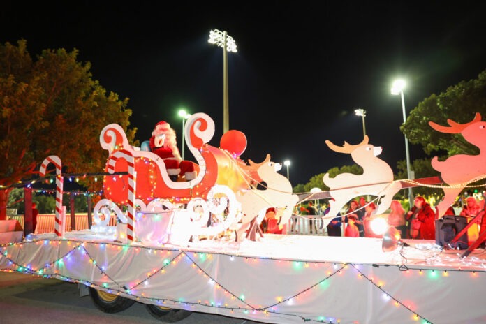 a parade float decorated with christmas lights and decorations