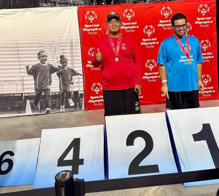 a couple of men standing on top of a podium