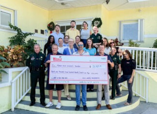 BEST OF UPPER KEYS RAISES RECORD FUNDS a group of people standing on a porch holding a large check