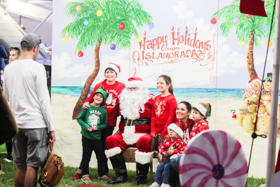 a group of people standing around a santa clause