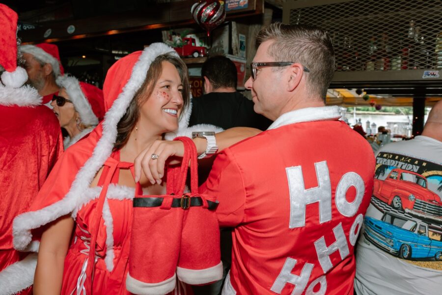 a group of people dressed up in santa costumes