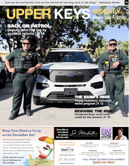 a couple of men standing next to a white truck