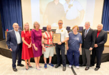 COUNTY OFFICIALS HONOR 75 YEARS OF THE TAVERNIER VOLUNTEER FIRE DEPARTMENT a group of people standing in front of a screen