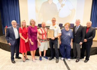 a group of people standing in front of a screen