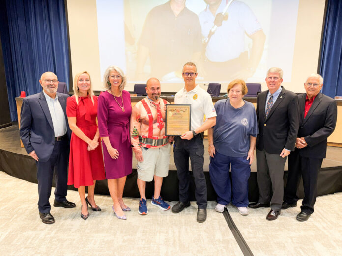 a group of people standing in front of a screen