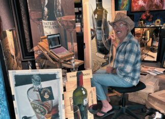 ARTIST THOMAS ARVID RETURNS TO KEY WEST GALLERY a man sitting in a chair next to a dog