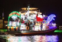 a boat decorated with christmas lights on the water