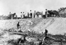 a group of men standing on top of a hill