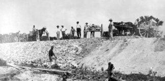 a group of men standing on top of a hill