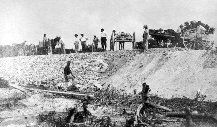 Upper Matecumbe Camp 4 sand fill Apr 20, 1906 (2) a group of men standing on top of a hill