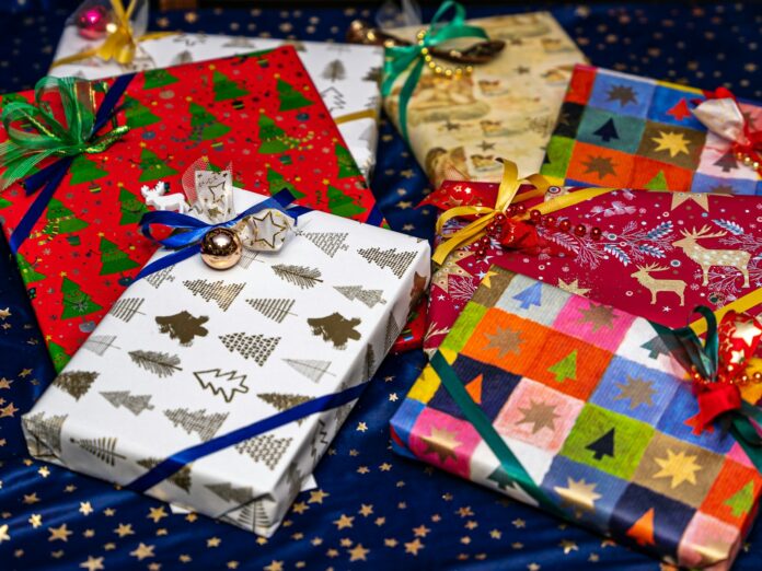 Photo by Patrick Pahlke a group of wrapped presents sitting on top of a table