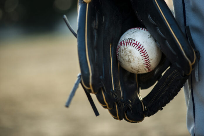 close-up-baseball-held-glove a baseball inside of a catchers mitt