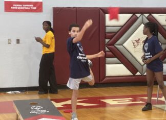 SPECIAL OLYMPICS ATHLETES SHINE a group of young people standing on top of a basketball court