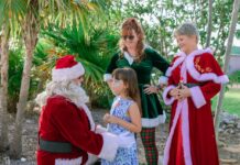 THIS WEEKEND: ENJOY ISLAND LIGHTS & A FESTIVE NIGHT AT THE PIGEON KEY HOLIDAY SPECTACULAR a group of people dressed up as santa claus