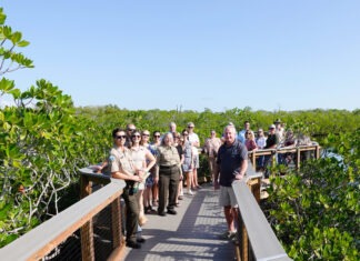 a group of people standing on a bridge