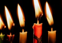 THE HOLIDAYS BRING INCREASED FIRE RISK a group of lit candles sitting next to each other
