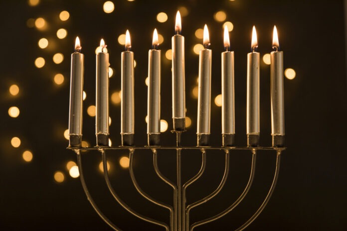 a menorah with lit candles on a table