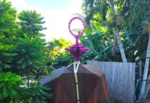 a sculpture in the middle of a garden