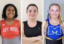 LADY LIFTERS MAKE GAINS BEFORE THE HOLIDAY BREAK a group of three women standing next to each other