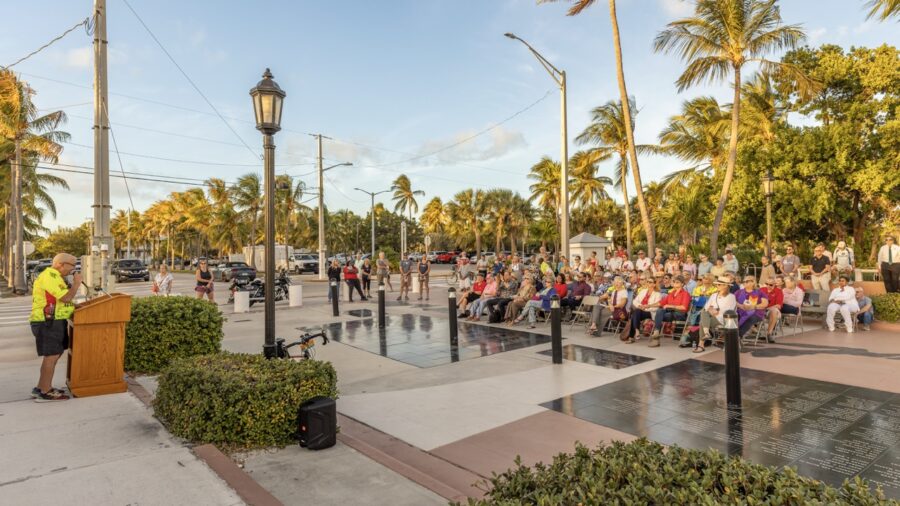 a man standing at a podium in front of a crowd of people