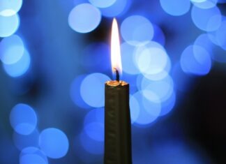 CORAL ISLES CHURCH HOSTS BLUE CHRISTMAS SERVICE lighted candle in bokeh photography
