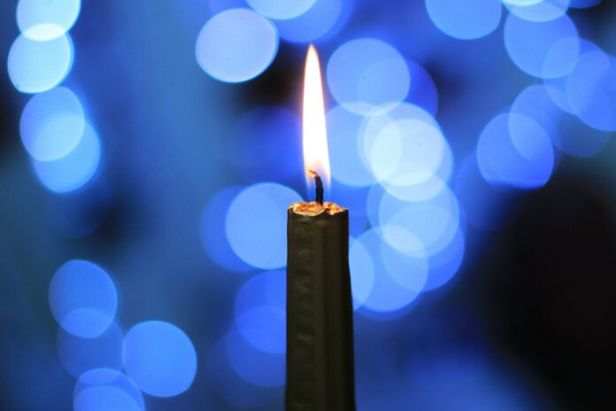 Photo by Laura Hope lighted candle in bokeh photography