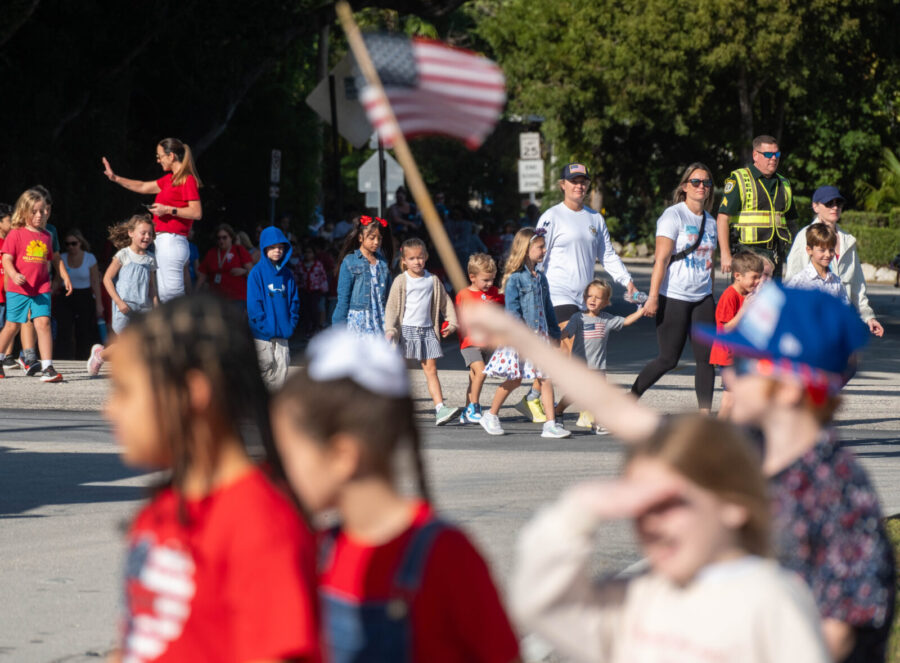 a crowd of people walking down a street