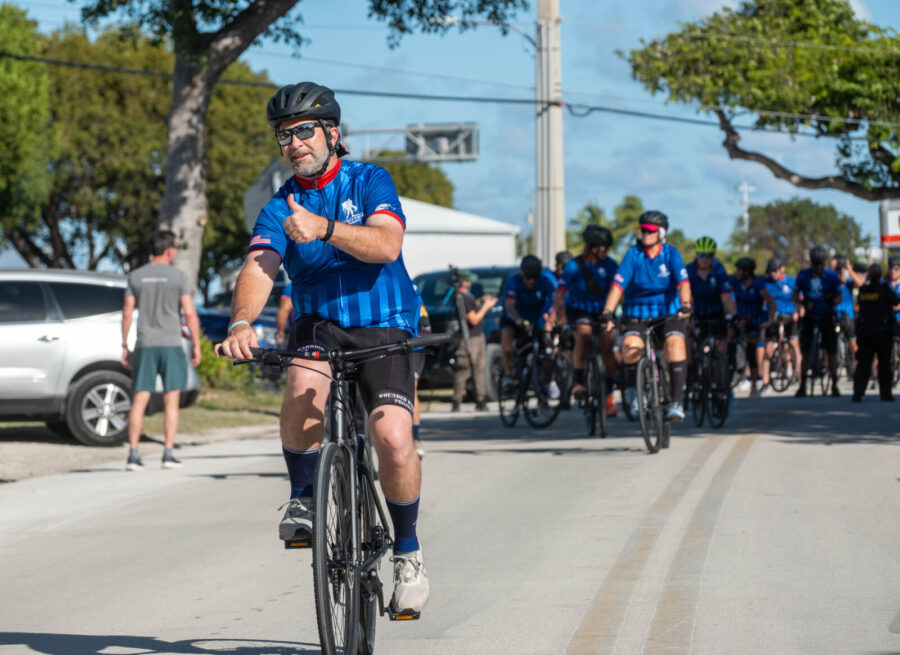 a group of people riding bikes down a street