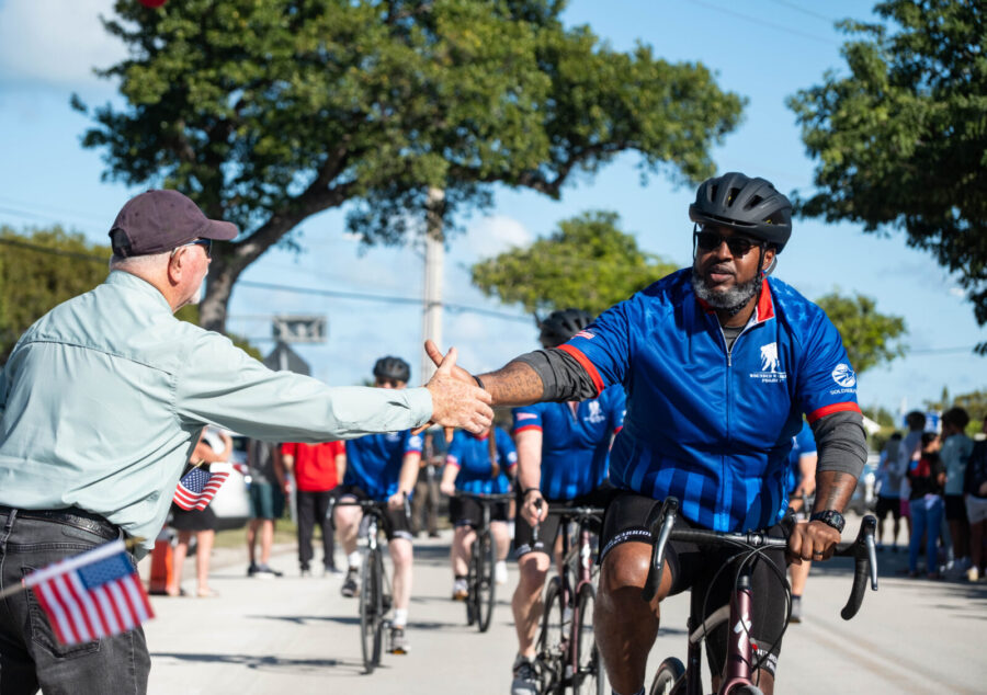 a group of people riding bikes down a street