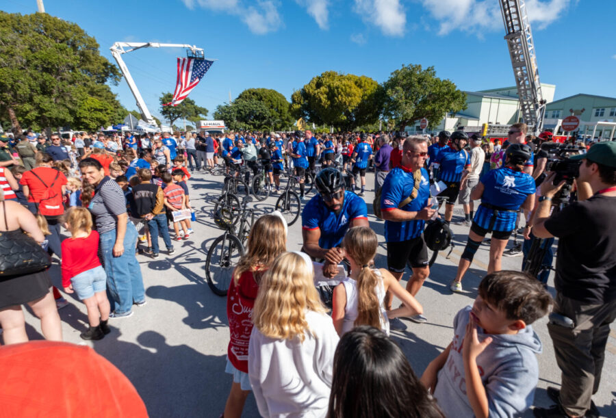 a large group of people standing around each other