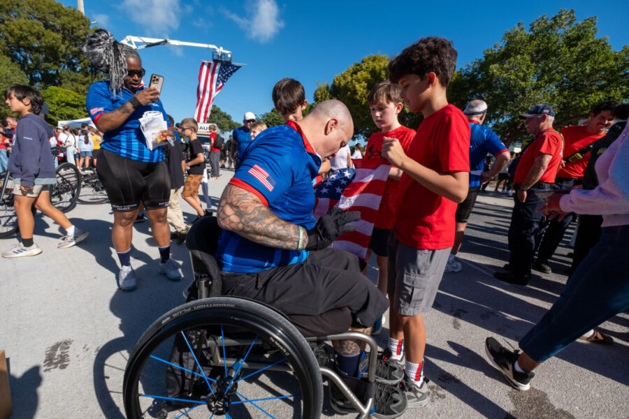 a man in a wheel chair in a crowd of people