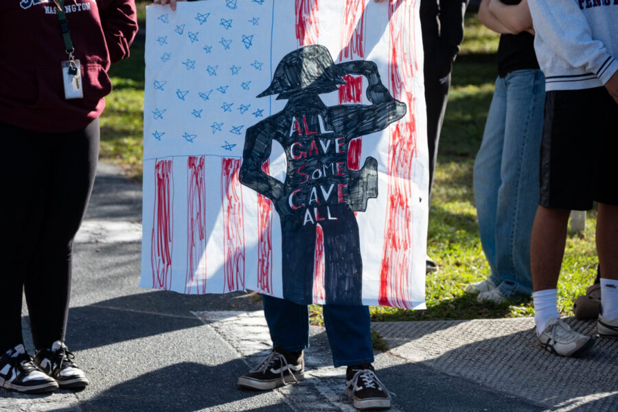 a group of people standing around a sign