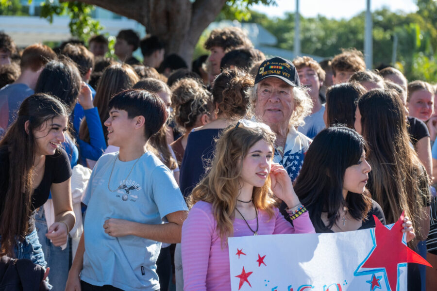 a group of people standing around each other holding signs