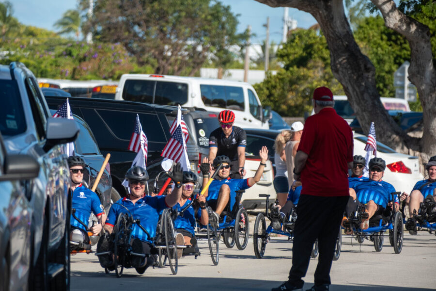 a group of people riding bikes down a street