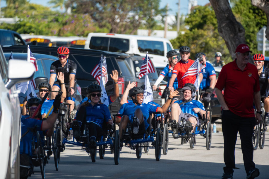 a group of people riding bikes down a street