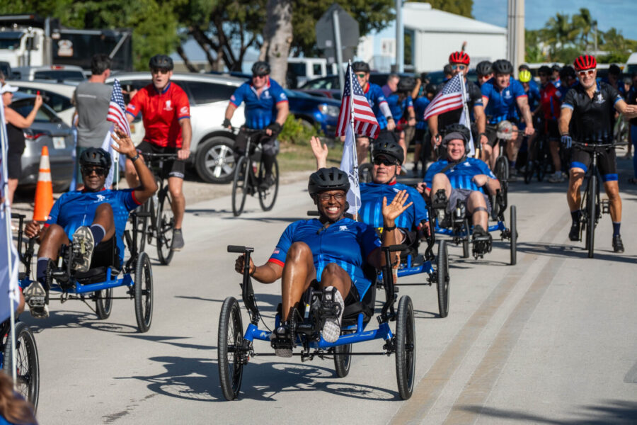 a group of people riding bikes down a street
