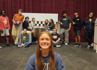 HIGH SCHOOL PLAYWRIGHT LILLIAN ANDREW DIRECTS HER OWN SHOW THIS WEEKEND a woman sitting on the floor in front of a group of people