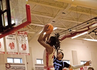 a group of young men playing a game of basketball