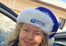 a woman in a car wearing a blue and white hat