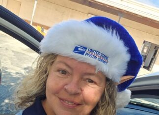 a woman in a car wearing a blue and white hat