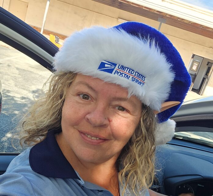 a woman in a car wearing a blue and white hat