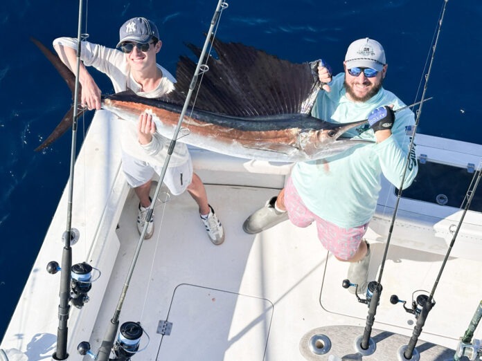 a couple of people on a boat with some fish