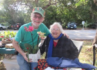 IN PICTURES: FESTIVAL BRINGS ARTS AND ALL SORTS OF ACTIVITY BENEATH THE OAKS IN ISLAMORADA a man and a woman standing next to each other