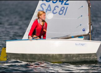 LARGEST YOUTH SAILING REGATTA IN THE FLORIDA KEYS RETURNS LATER THIS MONTH a woman in a red jacket is on a sailboat