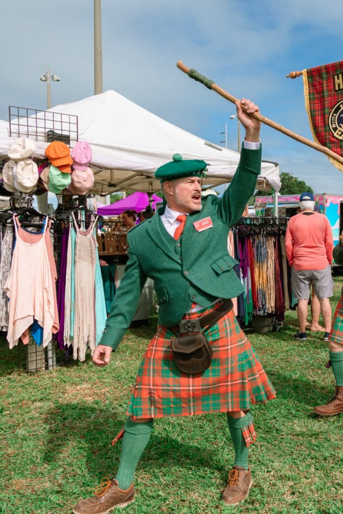 a man in a kilt holding a flag