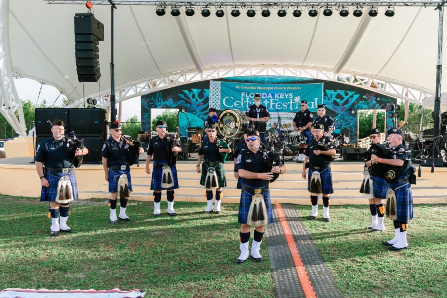 a group of people that are standing in the grass